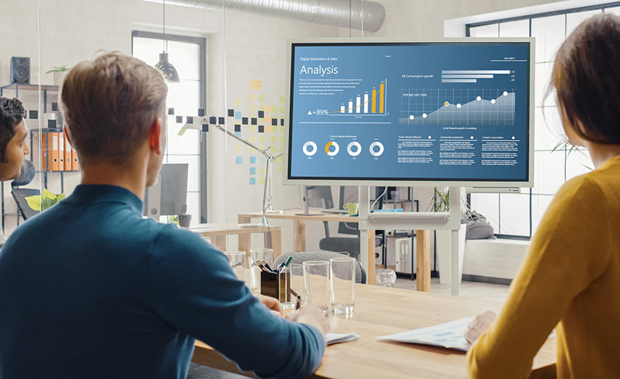 An image of three people reading data on a screen​